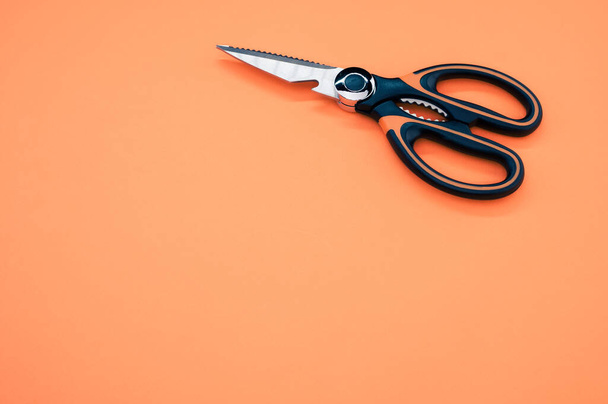 A closeup shot of scissors isolated on pink background. Cutting tool with zigzag blades, copy space - Foto, Imagem