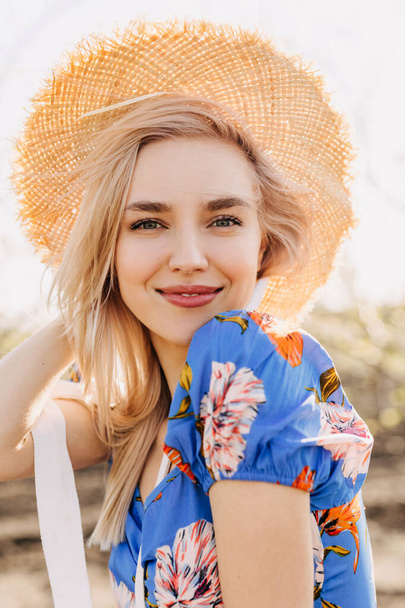 portrait of beautiful young blonde woman in dress on nature - 写真・画像