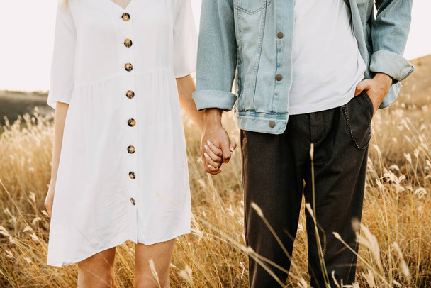 beautiful young couple holding hands on nature - Fotoğraf, Görsel