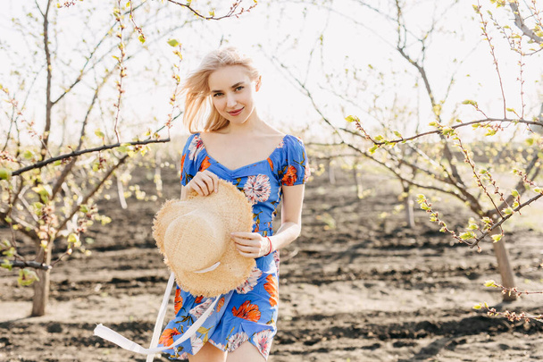 portrait of beautiful young blonde woman in dress on nature - Foto, immagini