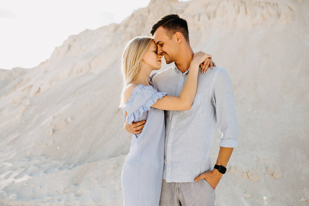 beautiful young couple embracing in sand quarry - Foto, Bild