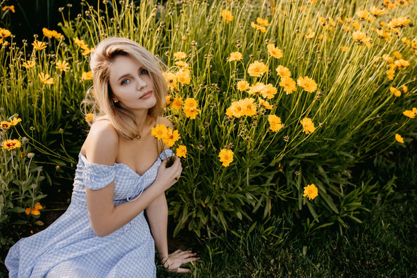 portrait of beautiful young woman in summer dress on green meadow with yellow flowers - Φωτογραφία, εικόνα
