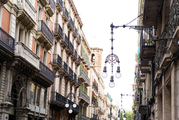 Old historic houses with windows, balconies and streetlight in Barcelona - 写真・画像