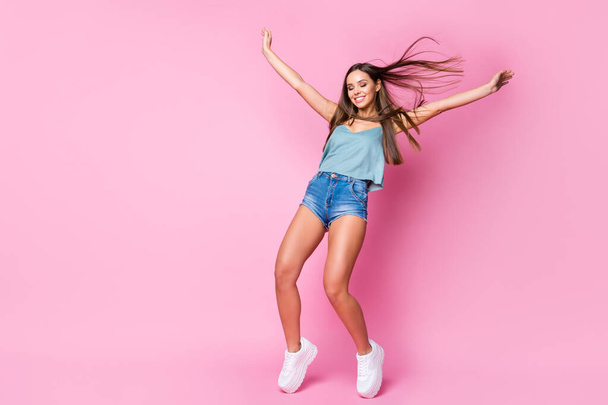 Full length body size view of her she nice attractive fascinating gorgeous cheerful dreamy brown-haired girl having fun standing in front of windy weather isolated over pink pastel color background - Foto, Imagem
