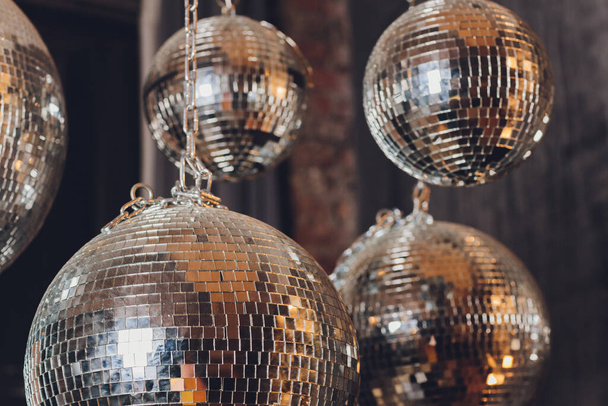 Sparkly disco ball hanging in an empty grungy room. - Φωτογραφία, εικόνα