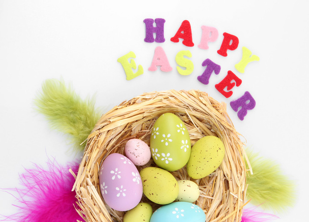 Easter eggs in nest and Happy Easter sign, isolated on white - 写真・画像