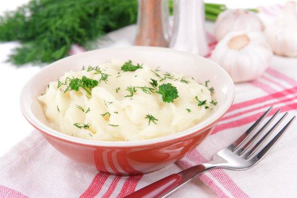 Delicious mashed potatoes with greens in bowl on table close-up - Photo, image