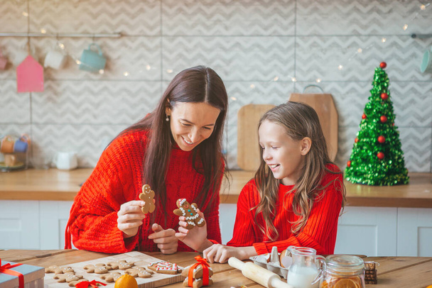 Happy family mother and daughter bake cookies for Christmas - Photo, Image