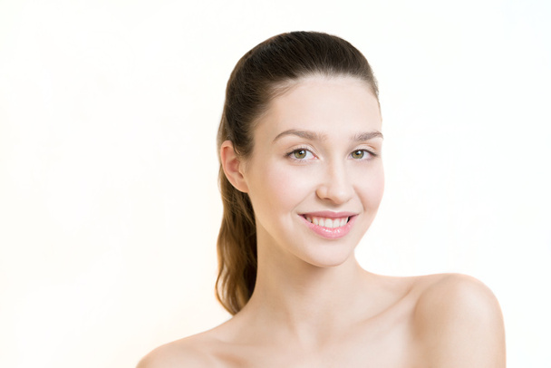 Beautiful young adult woman with clean fresh skin on white backg - Photo, Image