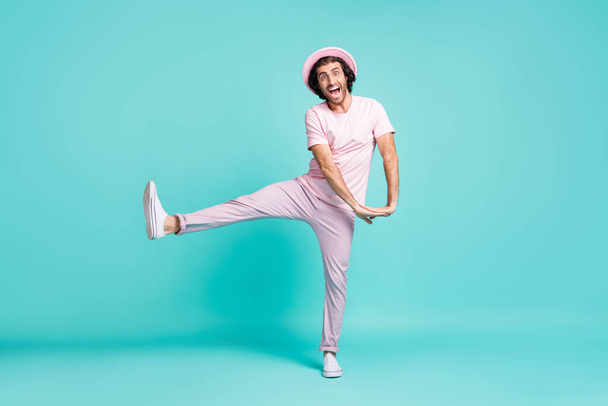 Full length photo of funny guy dancing wear cap t-shirt trousers sneakers isolated on teal color background - Фото, изображение