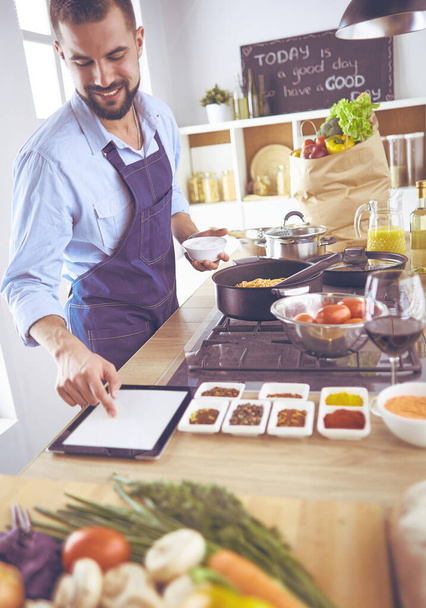 Man preparing delicious and healthy food in the home kitchen - Photo, Image