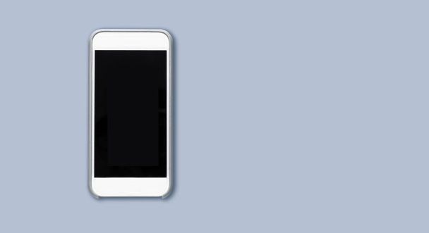 Top view of cell phone with black screen isolated on gray background with ample copytext space. Smartphone - Fotó, kép
