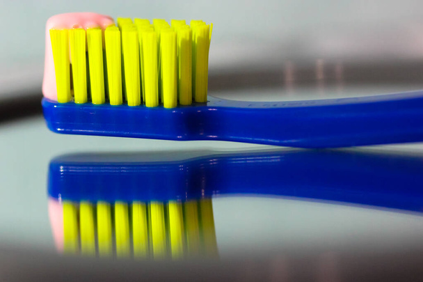 緑の毛を閉じると青歯ブラシミラー、ピンクの歯磨き粉に反映されます。日常生活のための口腔衛生と歯科ケア製品 - 写真・画像