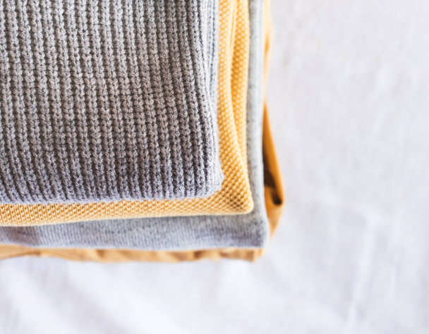 Yellow illuminated color and gray winter sweaters - Foto, imagen