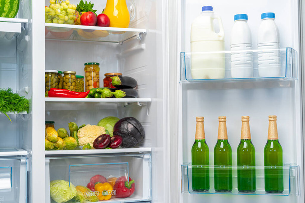 Open fridge full of fresh food and drinks - Foto, Imagen