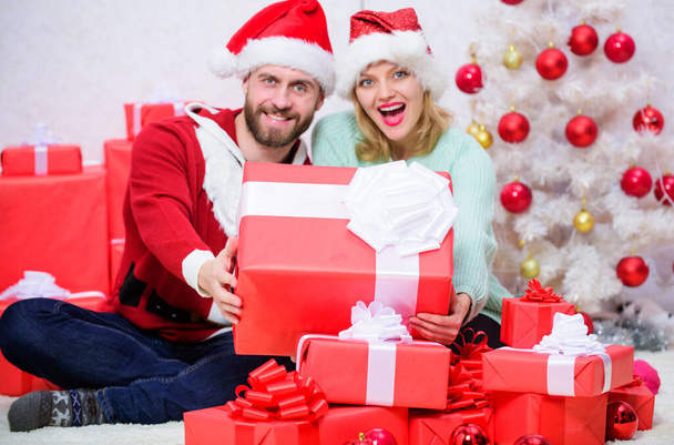 Love is best gift. Family married couple at home. Couple in love enjoy winter holiday celebration. Christmas eve with darling. Woman and bearded man in love sit near christmas tree background - Zdjęcie, obraz
