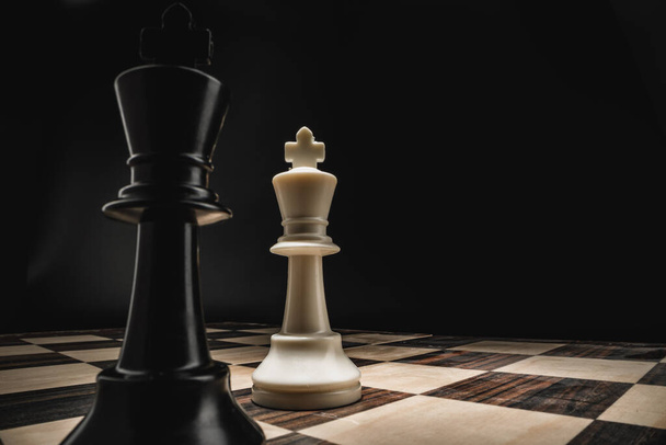 Chess board with figures on dark background - Фото, зображення