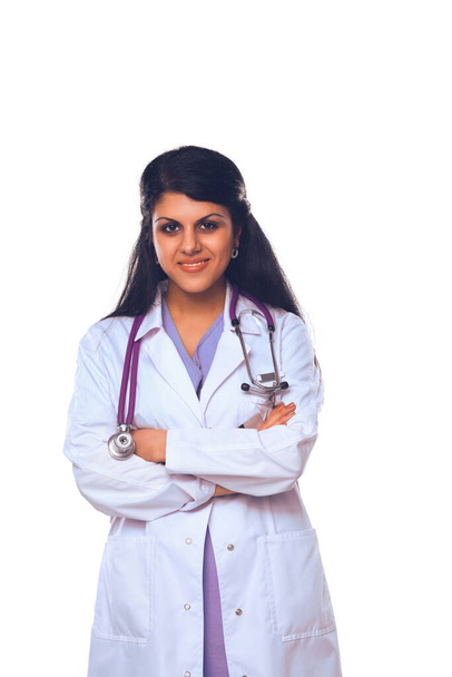 Doctor woman with stethoscope standing near wall - Foto, imagen