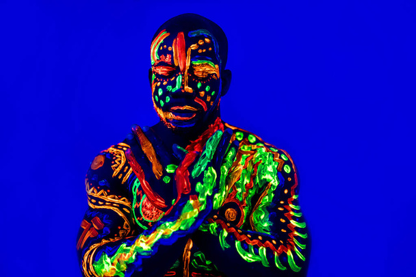 afro american man posing in studio shot with UV light - Фото, изображение