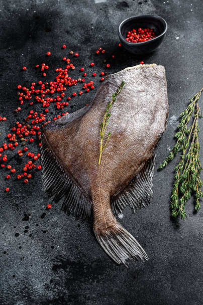 Raw fresh whole John Dory fish with spices and herbs for cooking. Black background. Top view - Foto, Bild