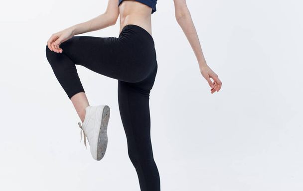 woman in black leggings cropped view Copy Space light background sport fitness - 写真・画像