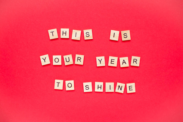 This is your year to shine. The inscription from wooden blocks on a bright red background. New Year. - Photo, image