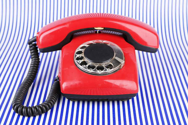 Red retro telephone on bright background - Foto, afbeelding