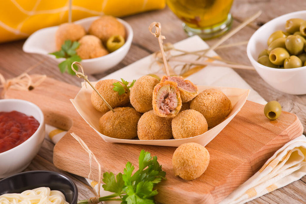 Ascoli stuffed olives with dipping sauce on cutting board. - Photo, Image