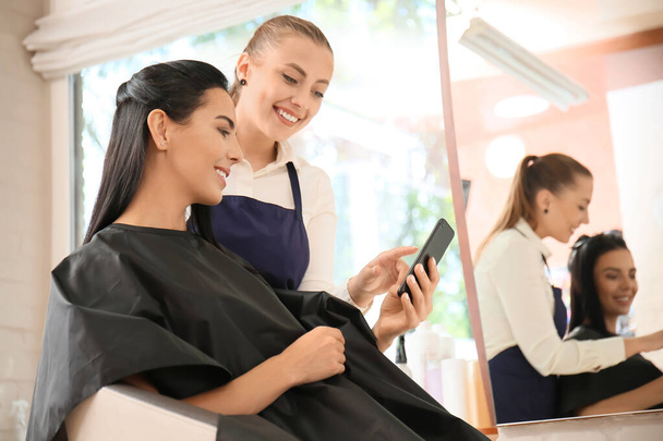 Female hairdresser working with client in salon - Fotografie, Obrázek