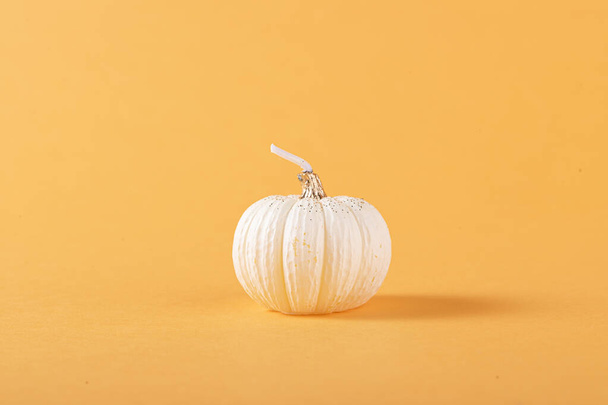 A closeup shot of fresh pumpkin isolated on orange background - Фото, изображение