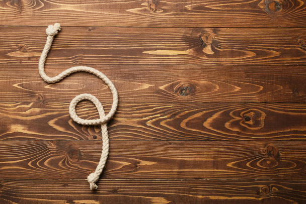 Rope with knot on wooden background - Photo, Image
