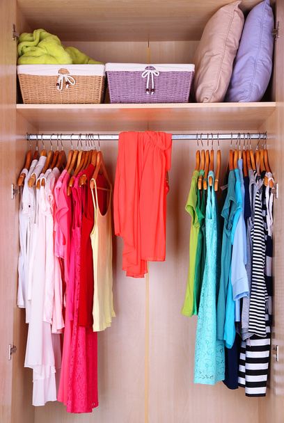 Female clothes on hangers in wardrobe - Foto, Imagen