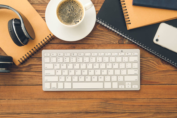 Computer keyboard, cup of coffee and gadgets on wooden background - Foto, Imagen