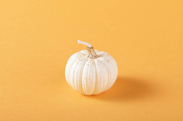A closeup shot of fresh pumpkins isolated on orange background - Foto, afbeelding