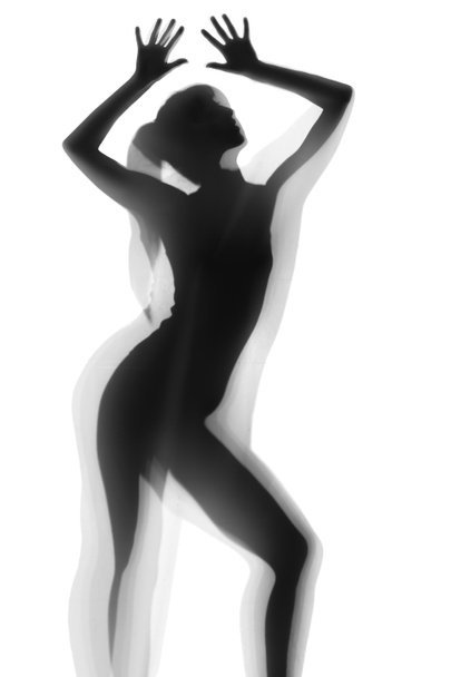 Silhouet van mooie sexy vrouw achter gordijn op witte achtergrond - Foto, afbeelding