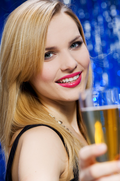 Smiling woman with glass of champagne - 写真・画像