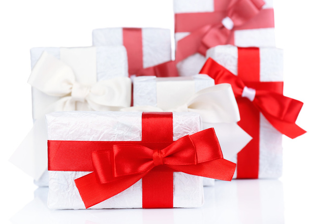 Beautiful gifts with red ribbons, isolated on white - Fotografie, Obrázek