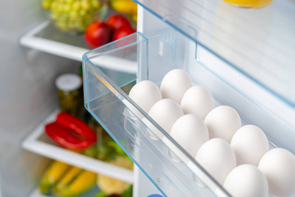 Pack of eggs on a fridge shelf - Photo, image