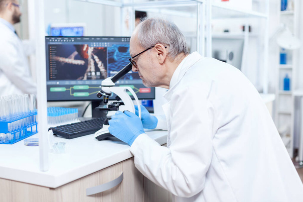 Senior caucasian scientist microbiology laboratory conducting virus analysis - Photo, Image