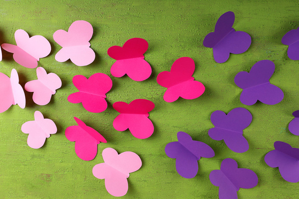 Paper cut out butterflies, on wooden background - Фото, изображение