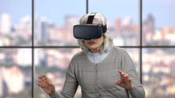 Mature woman wearing virtual reality headset. - Footage, Video