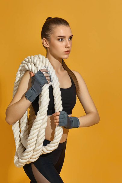 woman in black sportswear with heavy ropes - 写真・画像