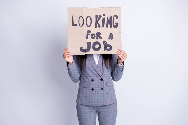 Photo of fired lady hold carton placard seek job hiding sad upset face stressed need money for living have two children search any offer formalwear plaid suit isolated grey color background - Φωτογραφία, εικόνα