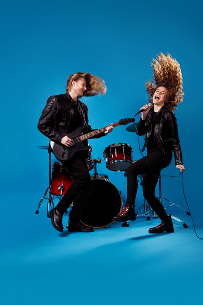 Full size photo crazy funky two people youth rock band woman sing song mic man play bass guitar enjoy night club garage studio performance event isolated bright blue color background - Foto, Bild