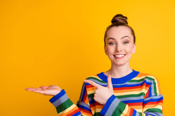 Portrait of positive cheerful promoter girl point index finger copyspace hand recommend choose decide advise promo ads wear sweater isolated over bright color background - 写真・画像