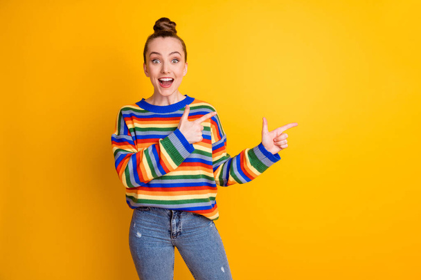 Photo of surprised girl promoter point index finger copyspace impressed advertisement promotion recommend suggest select choice decision wear pullover isolated shine color background - Фото, зображення