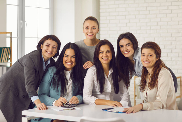 Smiling businesswomen looking at camera during brainstorming in office - Fotografie, Obrázek