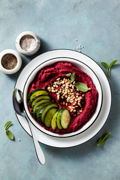 beetroot and cashew dip on a blue table with caramelized onions and vegan mayo. healthy snack or appetizer - Fotó, kép