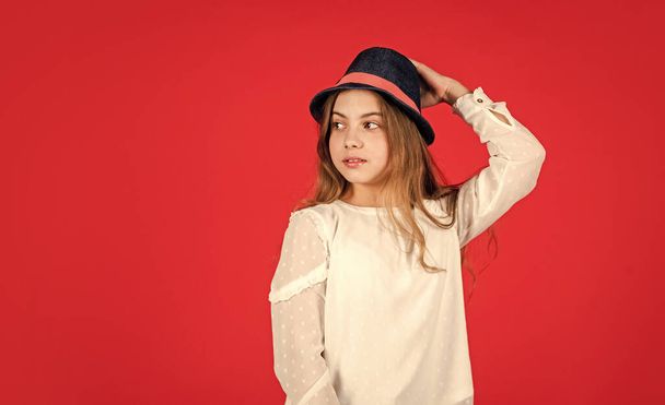 Fancy girl. Spring outfit. Individual style. Girl wear hat red background. Happy kid in hat. Fashion accessory. Summer accessory collection. Child wear hat. Accessories shop. Protect scalp sun rays - 写真・画像