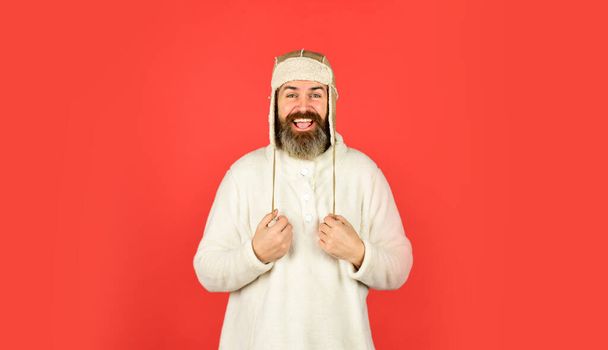 Warm clothes. Modern winter earflap beanie hat. Funky happy bearded man. mature man posing with funny outfit. man beard in winter hat. portrait of trendy guy wearing hat. Male winter style - Valokuva, kuva